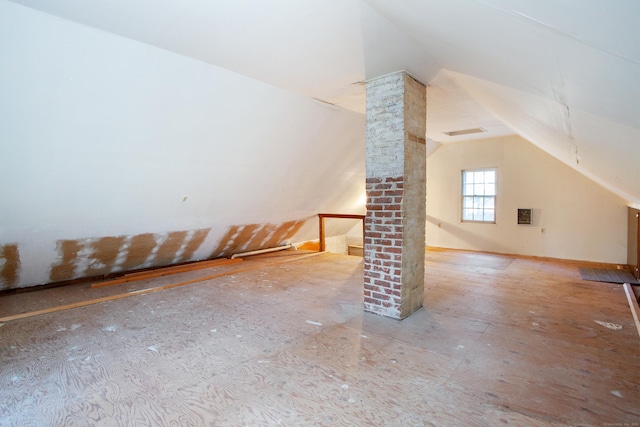 additional living space featuring ornate columns and vaulted ceiling