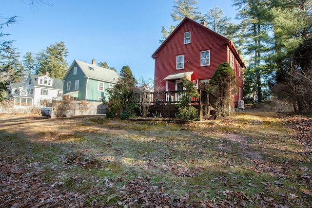 rear view of house featuring a wooden deck