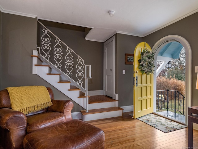 entrance foyer featuring hardwood / wood-style flooring and ornamental molding