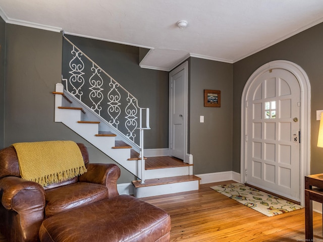 entryway featuring hardwood / wood-style floors and crown molding