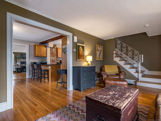 living room featuring hardwood / wood-style flooring and ornamental molding