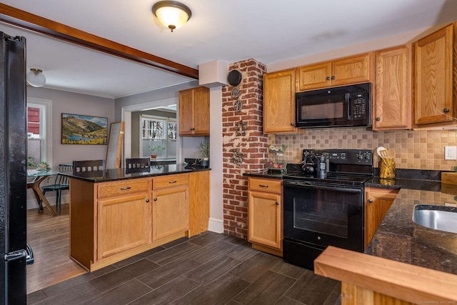 kitchen featuring black appliances, decorative backsplash, kitchen peninsula, and dark stone counters