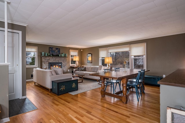 living room featuring crown molding, a fireplace, and hardwood / wood-style floors