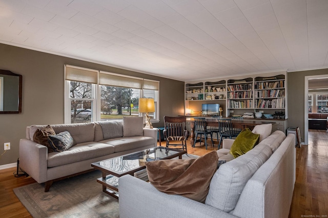 living room with hardwood / wood-style flooring, a healthy amount of sunlight, and crown molding