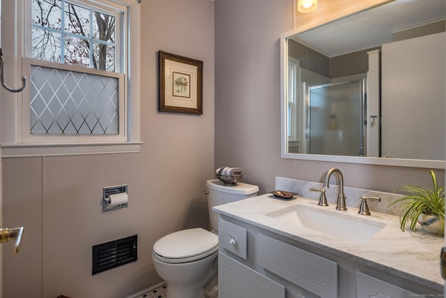 bathroom with vanity, toilet, and an enclosed shower