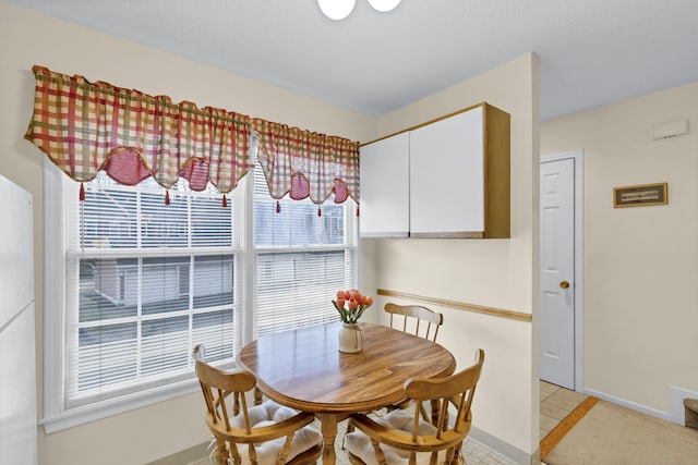 dining area with light tile patterned flooring