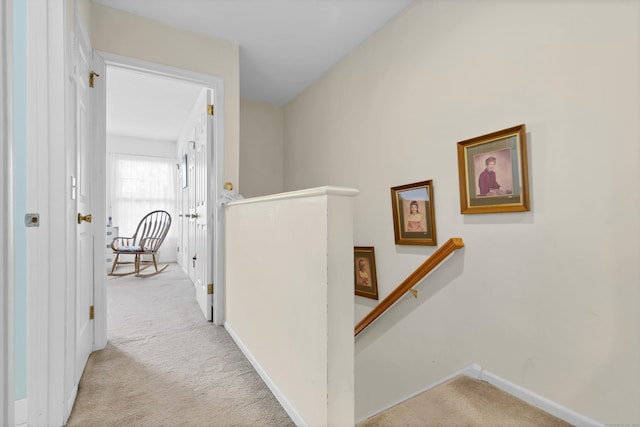 hall with light colored carpet