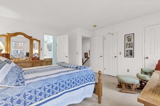 bedroom featuring carpet floors and connected bathroom