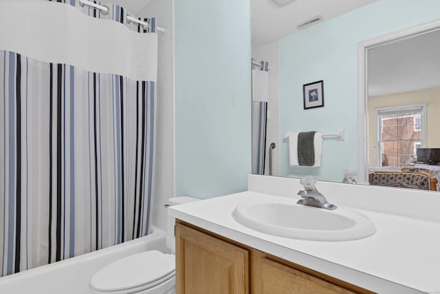 full bathroom with shower / tub combo, vanity, and toilet