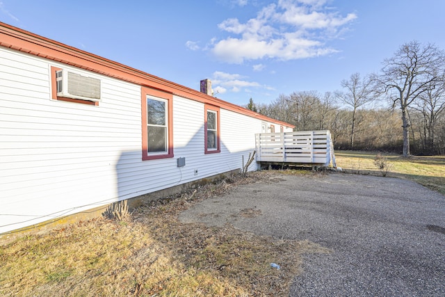 view of property exterior with a wooden deck