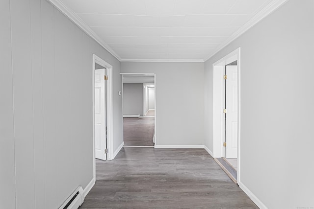 corridor with ornamental molding and hardwood / wood-style flooring