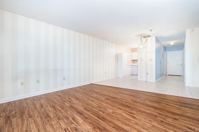 unfurnished living room featuring light hardwood / wood-style floors