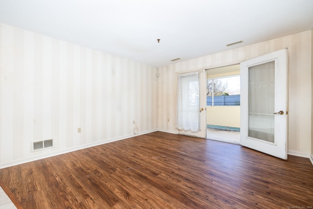 unfurnished room with dark hardwood / wood-style flooring and french doors