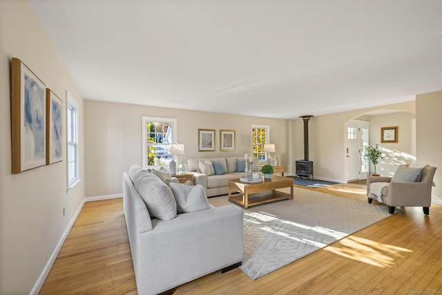 living room with light hardwood / wood-style flooring and a wood stove