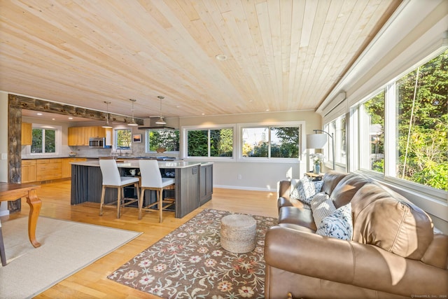 living room featuring sink, wooden ceiling, and light wood-type flooring