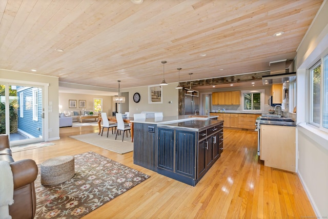 kitchen featuring wood ceiling, an island with sink, hanging light fixtures, and light hardwood / wood-style flooring