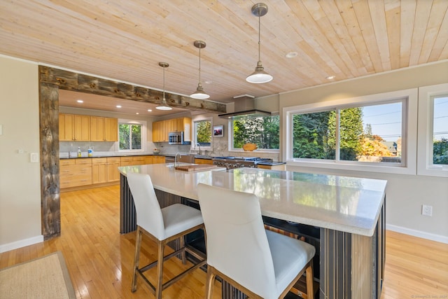 dining space with wood ceiling, sink, and light wood-type flooring