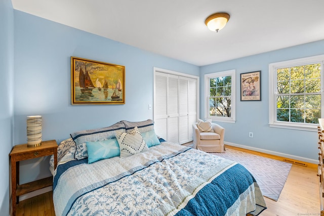 bedroom featuring light hardwood / wood-style flooring and a closet