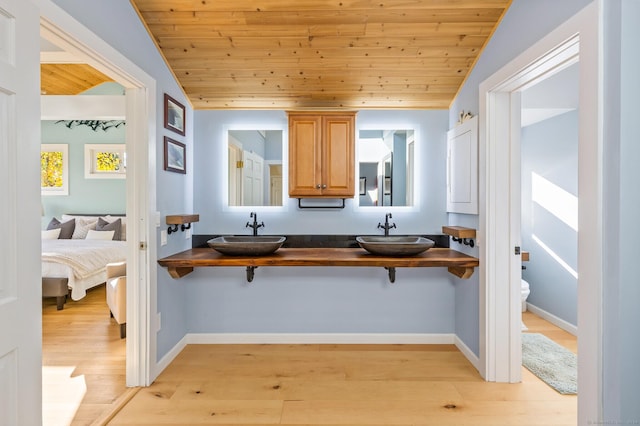 kitchen with sink, vaulted ceiling, and a breakfast bar area