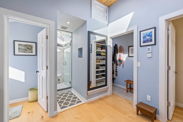 bathroom with hardwood / wood-style floors and a shower with door