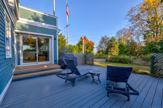 wooden terrace with a grill