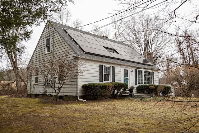 view of side of home featuring solar panels