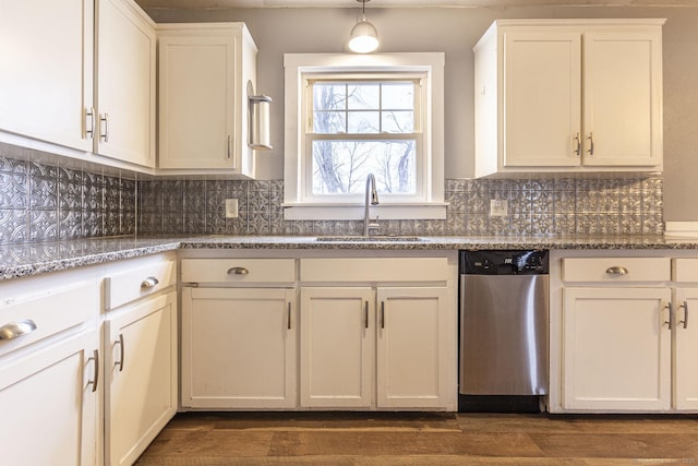 kitchen with stainless steel dishwasher, white cabinetry, sink, and tasteful backsplash