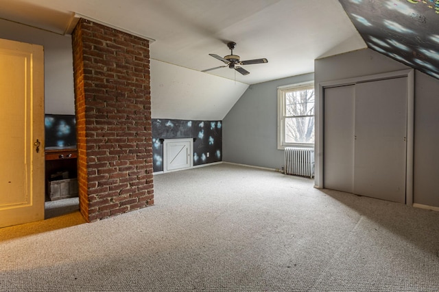 bonus room featuring light colored carpet, radiator, lofted ceiling, and ceiling fan