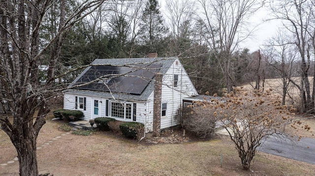 view of side of property with solar panels