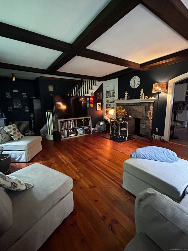 living room featuring beam ceiling, a fireplace, hardwood / wood-style floors, and coffered ceiling