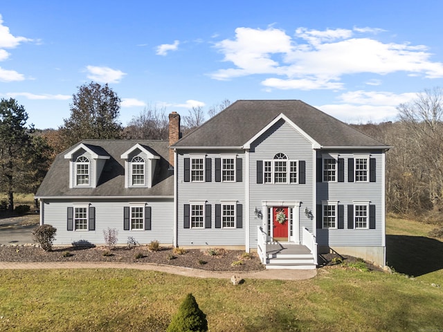 colonial home with a front lawn