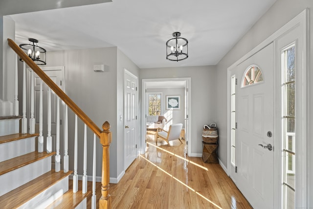 foyer with a chandelier and light wood-type flooring