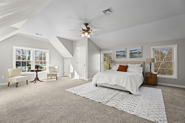 carpeted bedroom with ceiling fan and vaulted ceiling