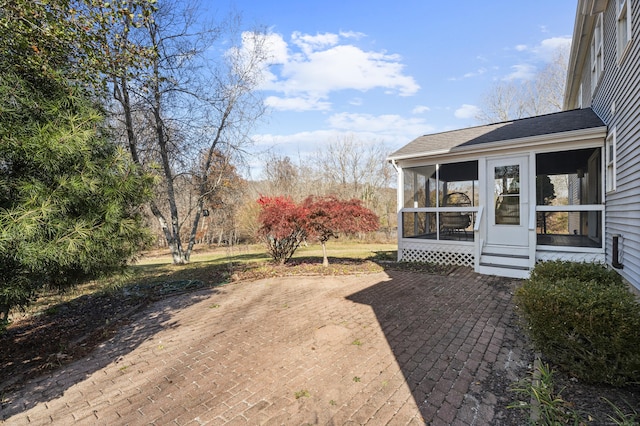 view of yard with a sunroom and a patio