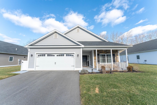 view of front facade featuring a garage, a porch, and a front yard