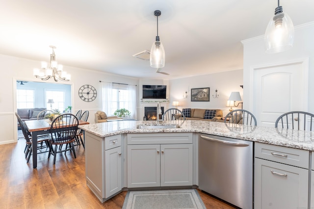 kitchen with gray cabinets, hanging light fixtures, and stainless steel dishwasher