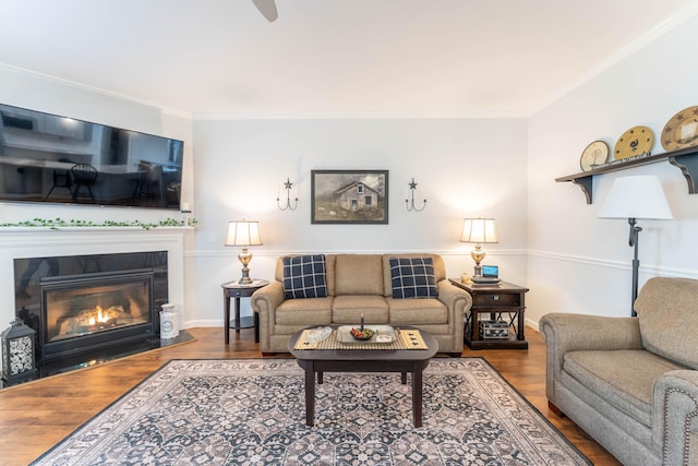 living room featuring hardwood / wood-style flooring and crown molding