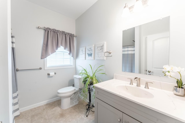 bathroom with tile patterned floors, vanity, and toilet