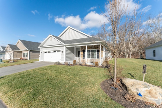 view of front of house featuring a front lawn, covered porch, and a garage