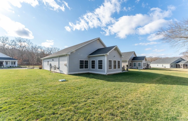 back of property featuring a yard