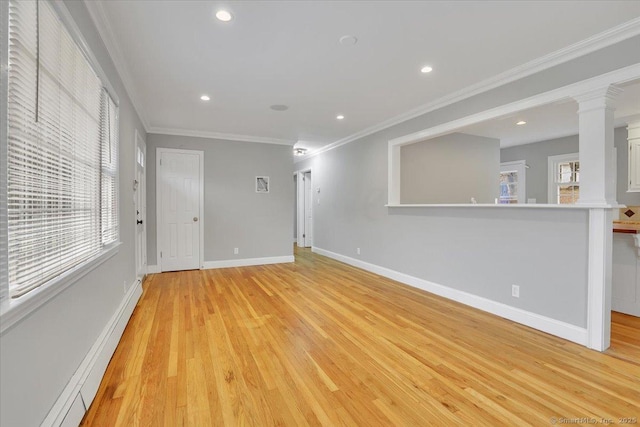 spare room featuring crown molding, light hardwood / wood-style floors, and a baseboard heating unit