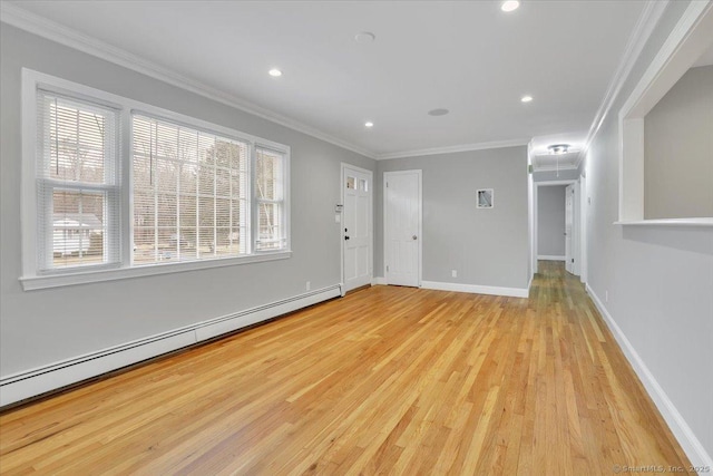 interior space with baseboard heating, light wood-type flooring, and ornamental molding