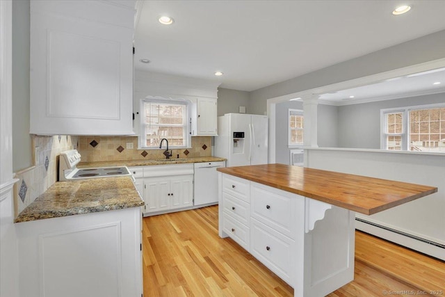 kitchen featuring decorative backsplash, sink, white cabinets, and white appliances