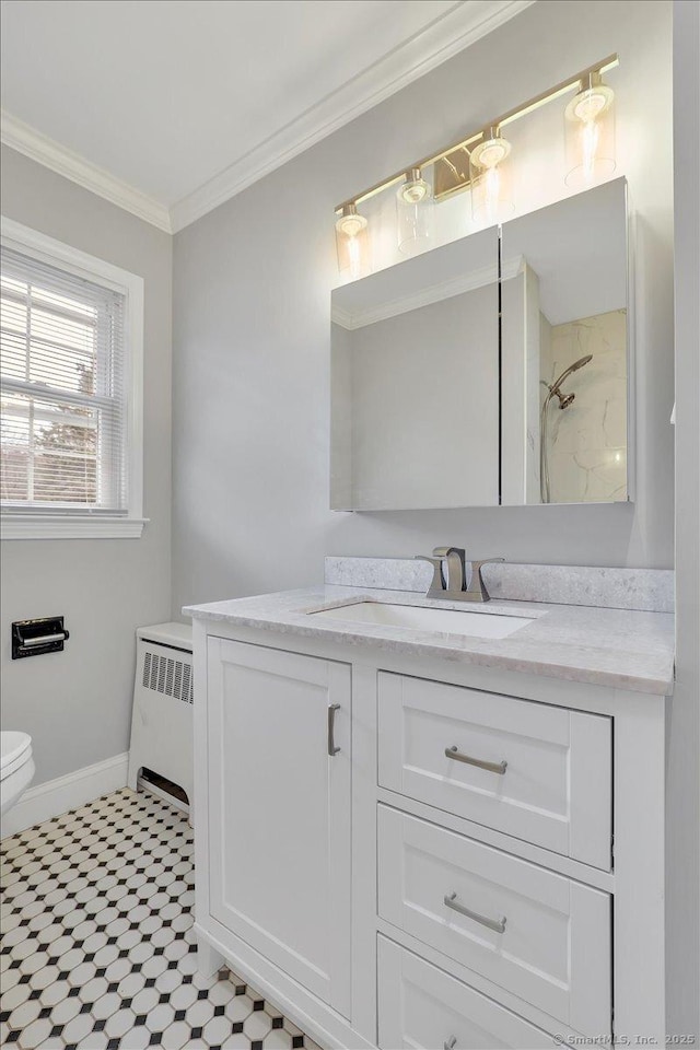 bathroom with vanity, toilet, radiator, and crown molding