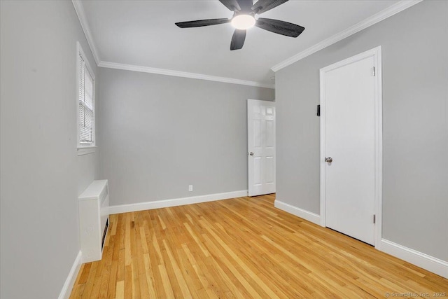 empty room with light hardwood / wood-style flooring, ceiling fan, and crown molding