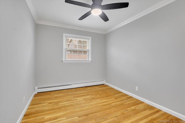 spare room with crown molding, light hardwood / wood-style floors, and a baseboard heating unit