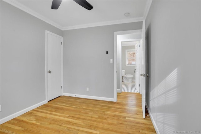 bedroom with connected bathroom, light hardwood / wood-style floors, ceiling fan, and crown molding