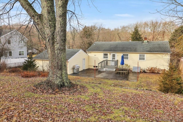 back of house with a patio area and a deck