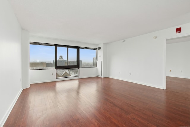 empty room featuring dark wood-type flooring