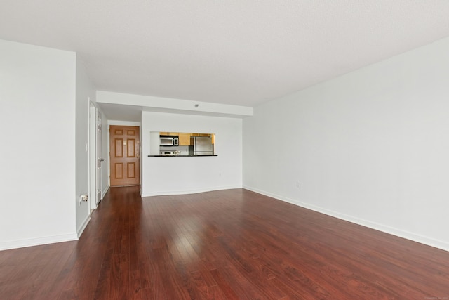 unfurnished living room with dark hardwood / wood-style flooring